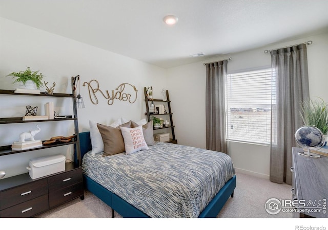 bedroom with light colored carpet