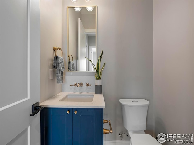 bathroom with toilet and vanity