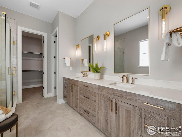 bathroom with a shower with door and vanity