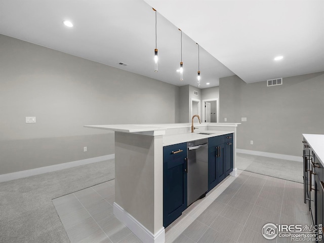 kitchen featuring visible vents, blue cabinetry, a center island with sink, stainless steel dishwasher, and a sink