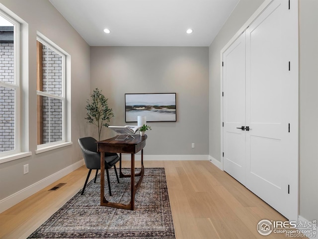 office featuring light wood-style flooring, recessed lighting, baseboards, and visible vents