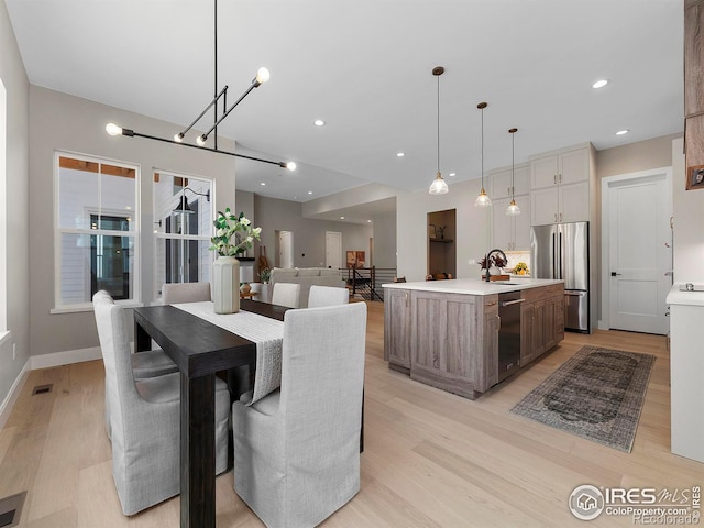 dining space featuring visible vents, recessed lighting, light wood-type flooring, and baseboards