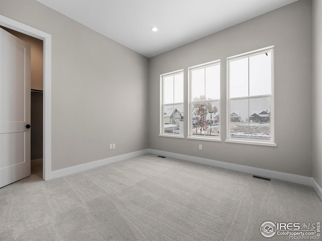 spare room with visible vents, recessed lighting, baseboards, and carpet