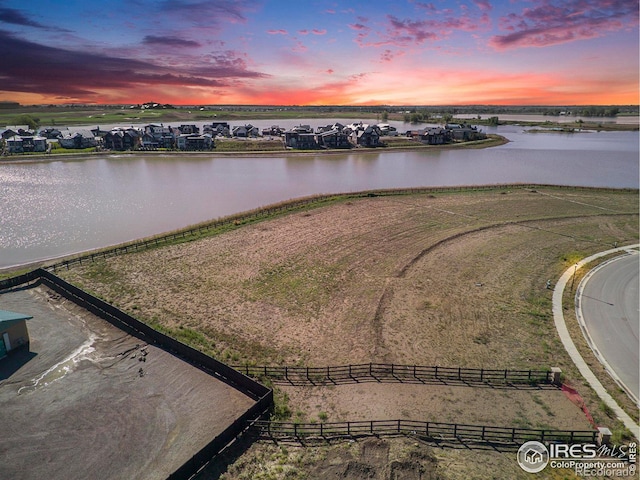 aerial view at dusk with a water view