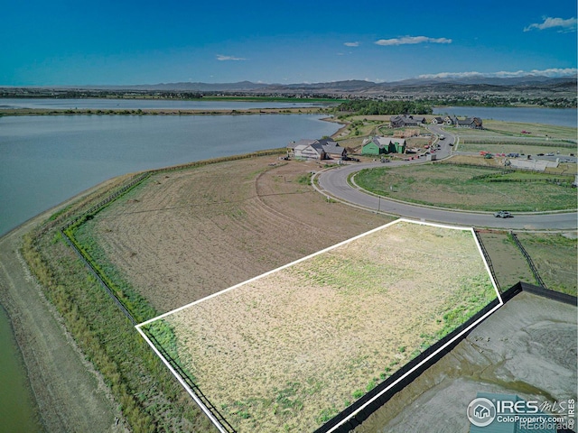 birds eye view of property with a water and mountain view