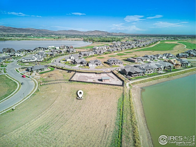 drone / aerial view featuring a water and mountain view