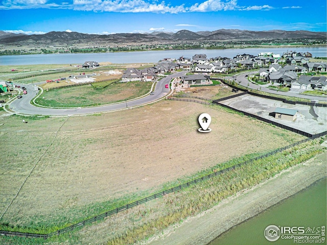 aerial view featuring a water and mountain view