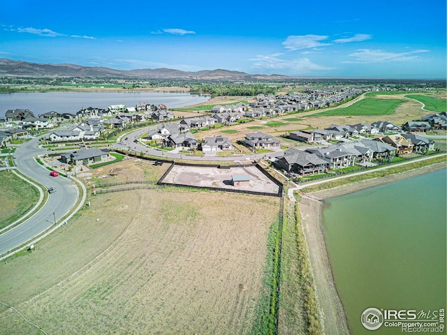 drone / aerial view with a water and mountain view