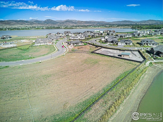 aerial view featuring a water and mountain view