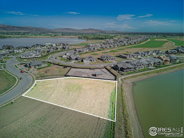 aerial view featuring a water and mountain view