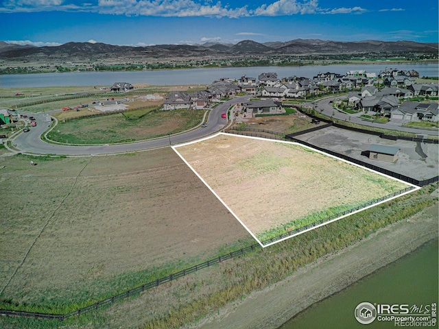 bird's eye view with a water and mountain view