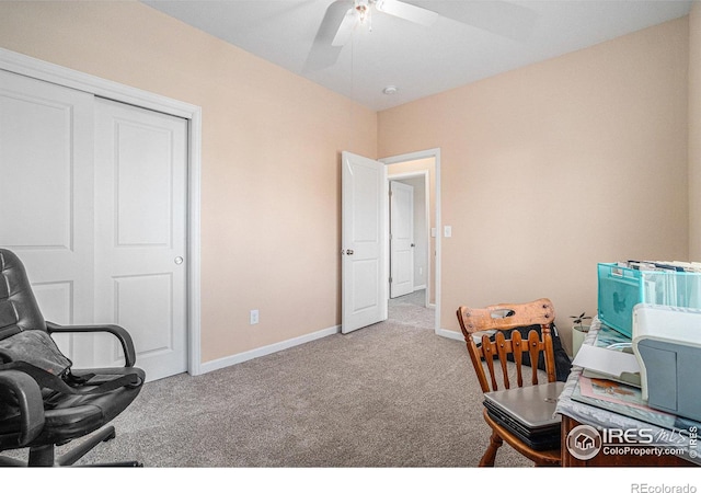 carpeted home office featuring ceiling fan