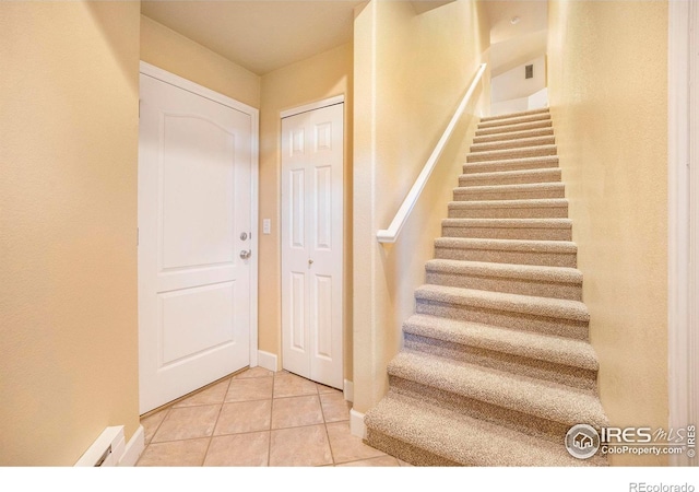 stairway with tile patterned flooring