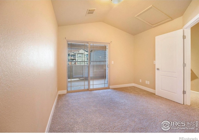 carpeted spare room featuring lofted ceiling