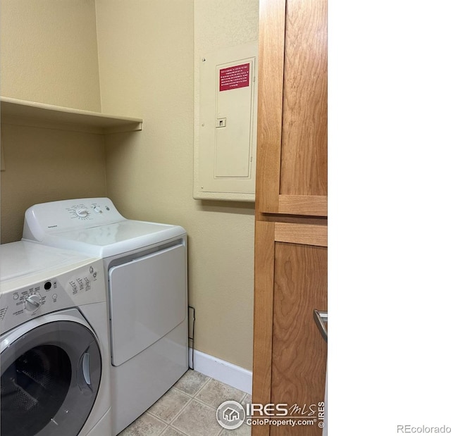 laundry area with washing machine and dryer, electric panel, and light tile patterned flooring