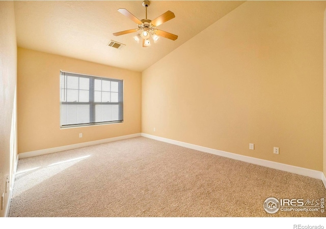 empty room with carpet, vaulted ceiling, and ceiling fan