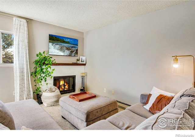 living room featuring a textured ceiling and a baseboard radiator