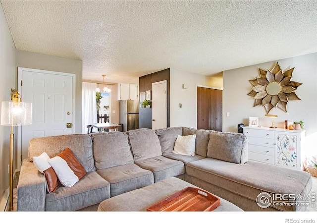 living room featuring a notable chandelier and a textured ceiling