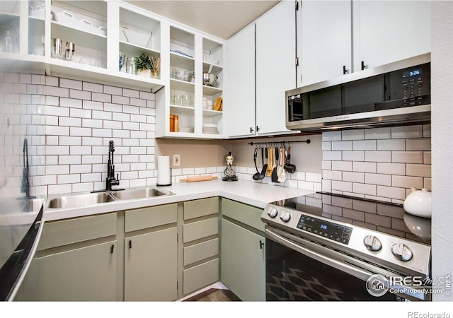 kitchen featuring stainless steel appliances, white cabinetry, tasteful backsplash, and sink