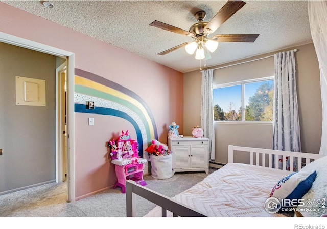 bedroom with baseboard heating, light carpet, a textured ceiling, and baseboards