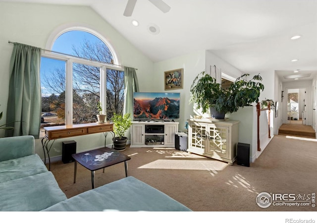 carpeted living room featuring plenty of natural light, ceiling fan, and vaulted ceiling