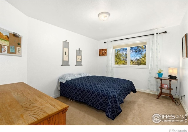 bedroom featuring light carpet