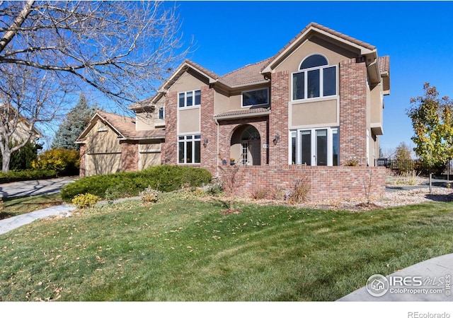 378 High Pointe Dr, Fort Collins, CO 80525 - view of front of home featuring a front lawn, a tile roof, and stucco siding