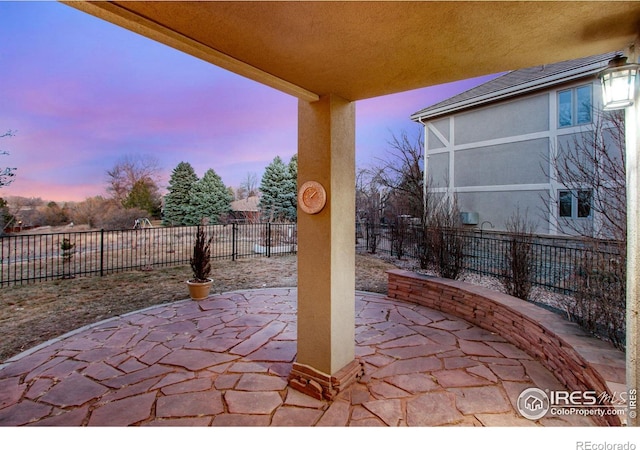 378 High Pointe Dr, Fort Collins, CO 80525 - patio terrace at dusk featuring a fenced backyard