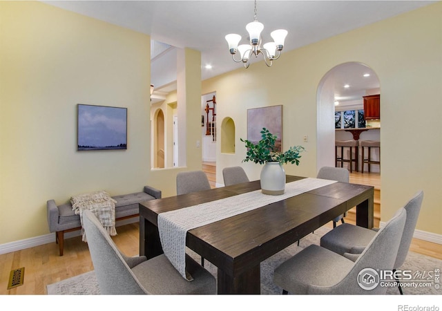 378 High Pointe Dr, Fort Collins, CO 80525 - dining room with arched walkways, a chandelier, light wood finished floors, baseboards, and recessed lighting