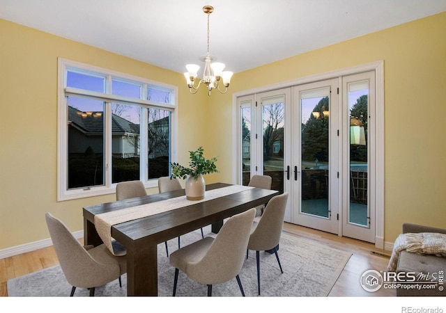 378 High Pointe Dr, Fort Collins, CO 80525 - dining room featuring a chandelier, healthy amount of natural light, baseboards, and light wood-style flooring
