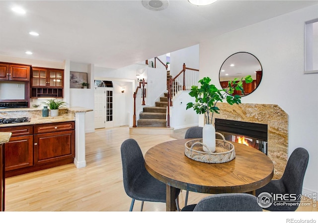 378 High Pointe Dr, Fort Collins, CO 80525 - dining space featuring stairs, light wood-style floors, baseboards, and recessed lighting