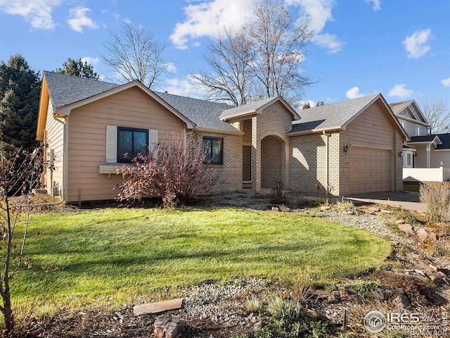 view of front facade with a garage and a front lawn