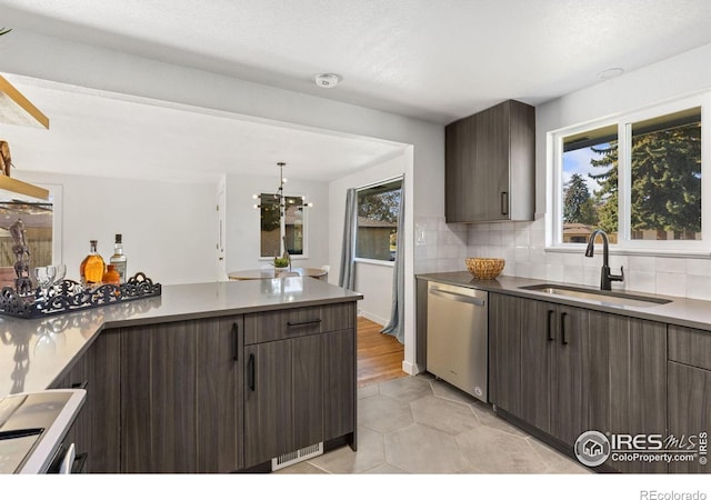 kitchen featuring backsplash, sink, dark brown cabinetry, and stainless steel appliances