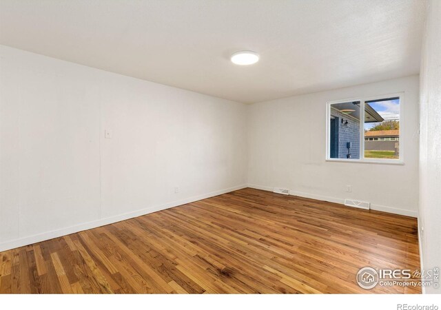 spare room featuring wood-type flooring