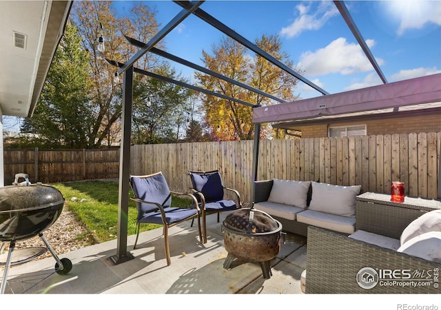 view of patio featuring area for grilling and an outdoor living space with a fire pit