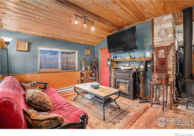 living room with wood walls, light hardwood / wood-style flooring, vaulted ceiling with beams, a baseboard radiator, and wood ceiling