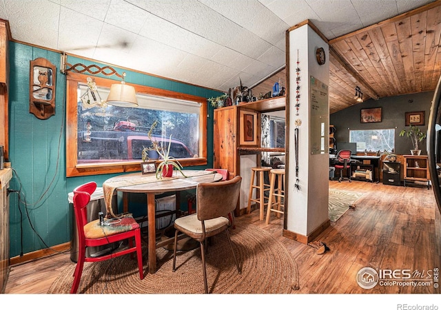 dining space featuring hardwood / wood-style flooring and lofted ceiling