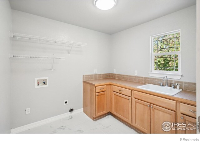 washroom with hookup for an electric dryer, cabinets, sink, and hookup for a washing machine