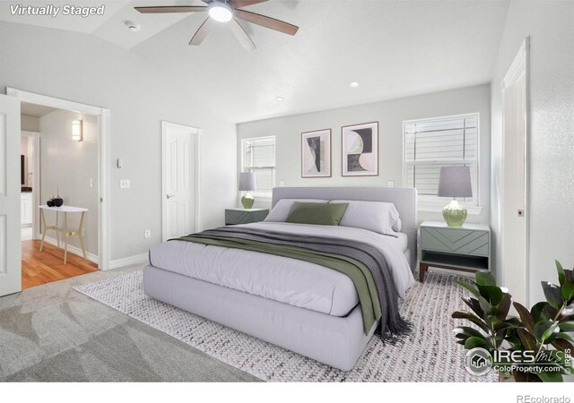 bedroom featuring ceiling fan, light wood-type flooring, and vaulted ceiling