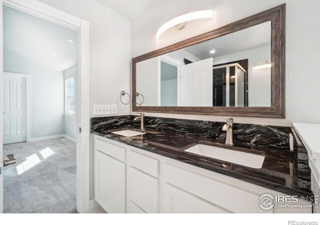 bathroom with vanity and vaulted ceiling