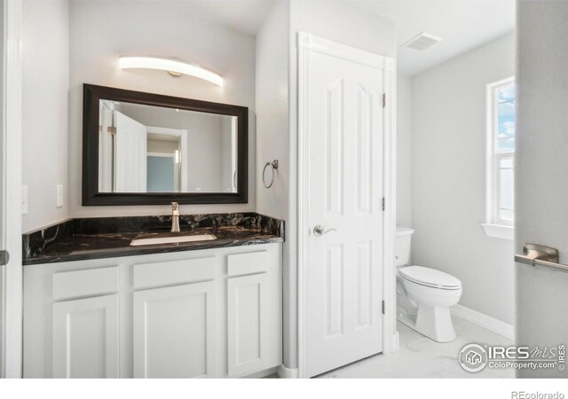 bathroom featuring vanity and toilet