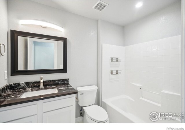 full bathroom featuring shower / bathing tub combination, vanity, and toilet