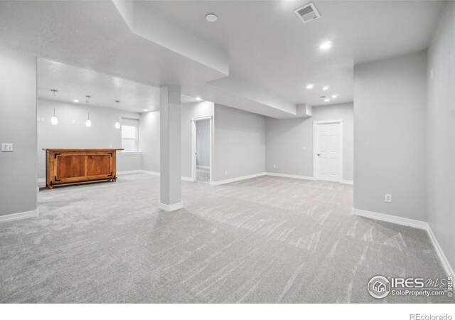 basement featuring light colored carpet