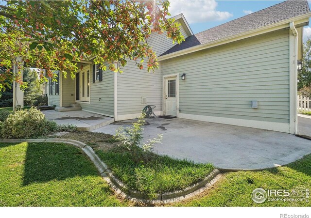 back of property with a patio