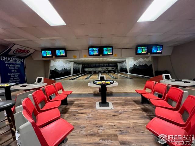 game room with bowling and hardwood / wood-style floors