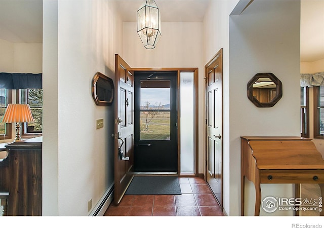 tiled foyer with an inviting chandelier and baseboard heating