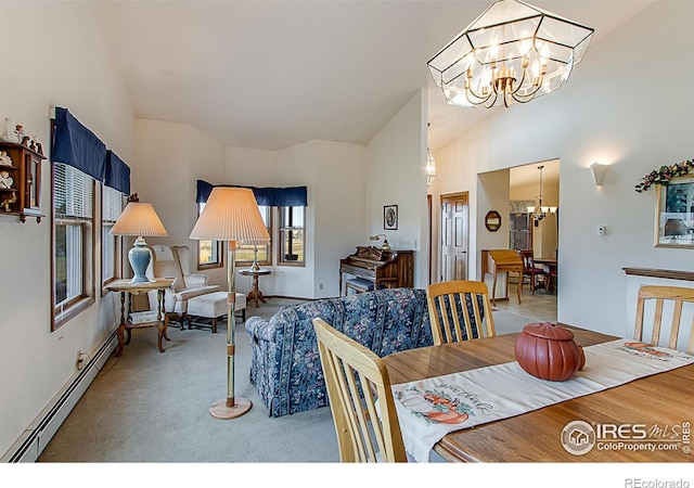 dining space with an inviting chandelier, lofted ceiling, and a baseboard radiator