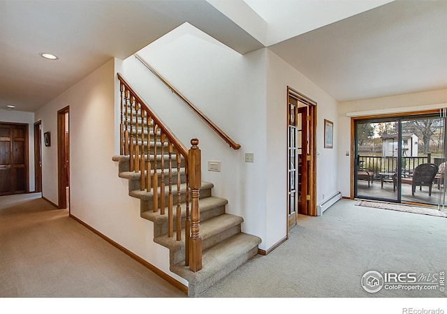 entrance foyer with light carpet and a baseboard heating unit