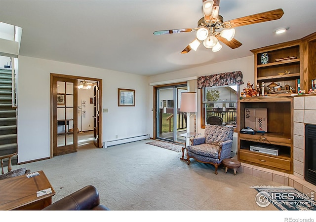 carpeted living room featuring a tile fireplace, ceiling fan, and a baseboard radiator