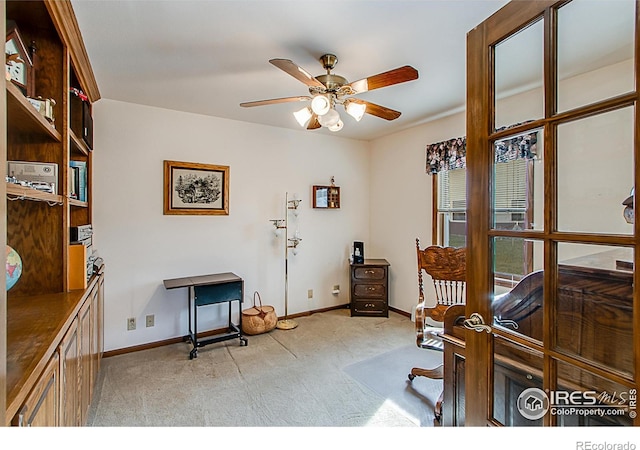 sitting room featuring light colored carpet and ceiling fan